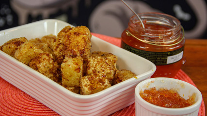 Brazilian snack tapioca cheese cubes served with pepper jelly (dadinho de tapioca)