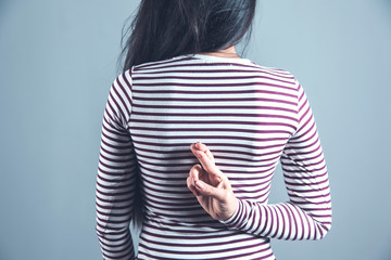 woman finger cross in back