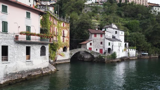 Nesso village with the bridge &ldquo;Ponte della Civera&rdquo; and the beautiful waterfall behind it