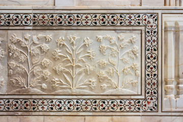 details of the bas-reliefs and floral inlays of the taj mahal in Agra, India