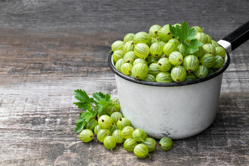 Fresh ripe green gooseberry on wooden background