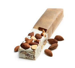 Homemade nougat bar with almonds isolated on white