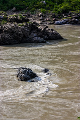 stream of the river Ganges fringing on the rocks near Rishikesh, Uttarakhand, India