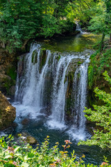 Waterfalls of Korana river in Rastoke village, near Slunj, Croatia, beautiful landscape with green trees on sunny summer day