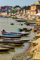 Fototapeta na wymiar Varanasi, India - August 20, 2009: boats on the banks of the Ganges in Varanasi, Uttar Pradesh, India