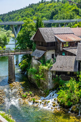 Fototapeta na wymiar Beautiful Rastoke village on Korana river, near Slunj, Croatia, old bridge, waterfalls and green countryside landscape on sunny summer day