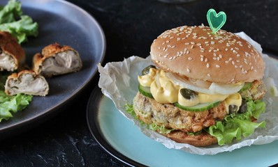 Brain Burger. Fried brains beef, calf or sheep are fried in deep fried as a cutlet in a burger. lettuce, cheese sauce, fresh cucumber and capers. fashionable exotic food. weird food