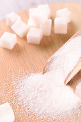 White cane sugar on a light wooden background