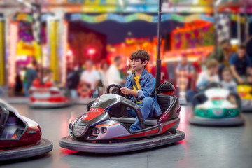 electric car boy at fair with lots of lights