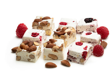 Homemade nougat bars with almonds and dried fruits isolated on white