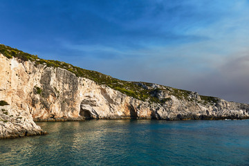 Fototapeta na wymiar Stone cliff with caves on the island of Zakynthos in Greece.