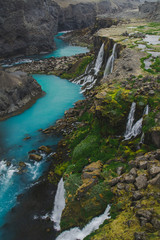Scenic landscape view of incredible Sigoldugljufur canyon in highlands with turquoise river, Iceland. Volcanic landscape on background. Popular tourist attraction.