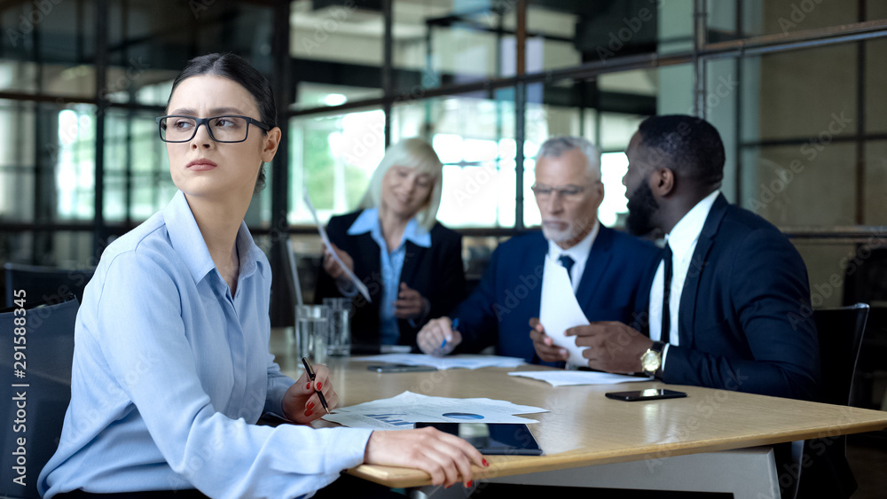 Wall mural sad female manager looking window during office meeting, workload tiredness