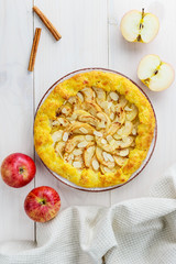 Apple galette with cinnamon and almonds on a wooden table. Homemade pie.