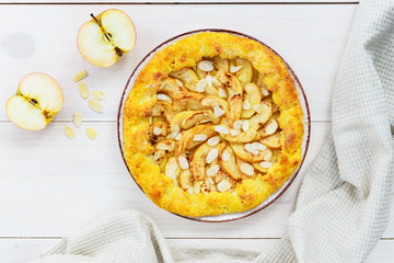 Apple galette with cinnamon and almonds on a wooden table. Homemade pie.