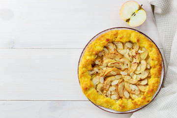 Apple galette with cinnamon and almonds on a wooden table. Homemade pie.