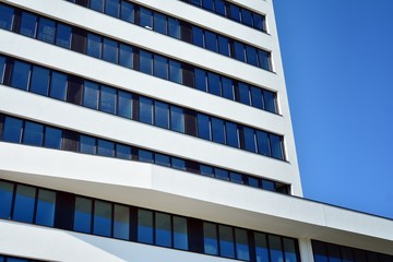 Facade fragment of a modern office building. Exterior of glass wall with abstract texture.