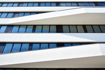 Obraz premium Facade fragment of a modern office building. Exterior of glass wall with abstract texture.