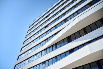 Facade fragment of a modern office building. Exterior of glass wall with abstract texture.