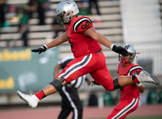 Fototapeta premium Great action photos of high school football players making amazing plays during a football game