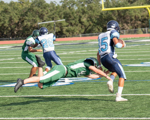 Fototapeta na wymiar Great action photos of high school football players making amazing plays during a football game