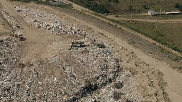 Aerial view of big landfill near city and sorting process. 4k