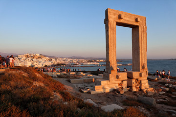 Sunset at Naxosos Portara, Apollo's 6th Cent BC temple ruins, overlooking Naxos town, Greek Islands	