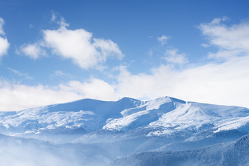 Winter landscape with snow capped mountains