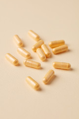 Coenzyme Q10 capsules. Dietary supplements. Bright paper background. Close up. Copy space. 