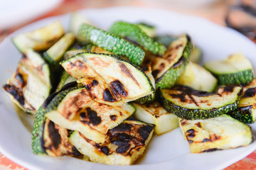 Grilled zucchini. Pieces of squash on a plate.