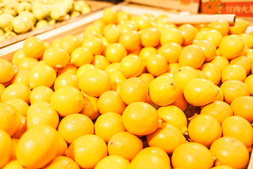 Baskets with lemons on the store counter. Vegetable on display in the supermarket