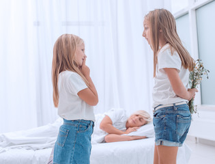 close up. two sisters standing in mom's bedroom on a holiday morning