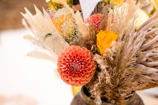 Autumn Bouquet Of Flowers In Natural Shades And Dried Flowers. Orange Dahlias, Yellow Roses, Protea, Spikelets