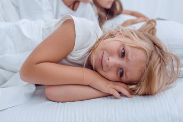 Obraz na płótnie Canvas pretty little girl lying on her parents bed