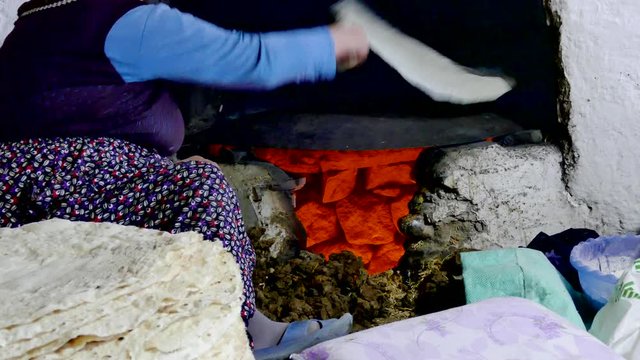women making yufka bread in tandoor,
