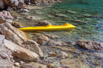 tropical rocky beach with kayak 