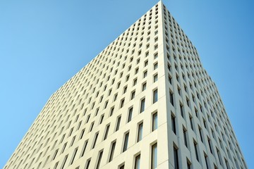 Modern office building detail. Perspective view of geometric angular concrete windows on the facade of a modernist brutalist style building. 