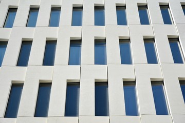 Modern office building detail. Perspective view of geometric angular concrete windows on the facade...