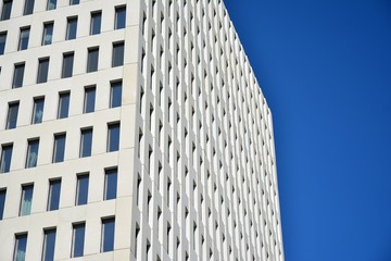 Modern office building detail. Perspective view of geometric angular concrete windows on the facade...