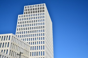 Modern office building detail. Perspective view of geometric angular concrete windows on the facade...