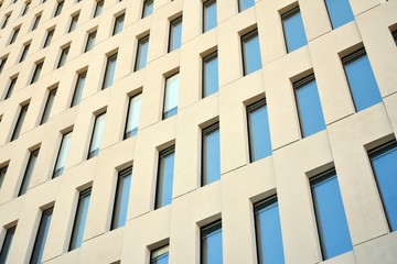 Modern office building detail. Perspective view of geometric angular concrete windows on the facade of a modernist brutalist style building. 