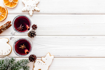 Mulled wine and fir branches frame on white wooden background top view space for text