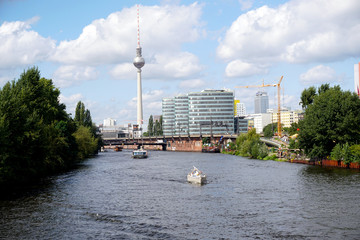 spree river with boats and the radio tower at Alexanderplatz in the background