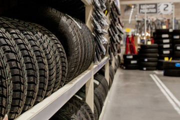 Fototapeta premium Car tires and wheels at warehouse in tire store.