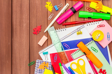 Back to school concept. School education supplies on brown wooden boards background
