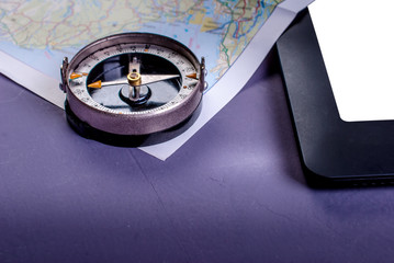 Close-up of old compass, tablet and map