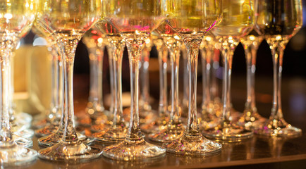 Row of empty glasses for red wine. Banquet preparation. Clean elegant glasses in a restaurant before a party or holiday are displayed by a barista for preparing cocktails or spirits