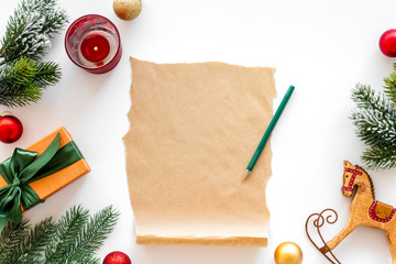 Letter to Santa Claus concept. Paper on white background with New Year decoration top view mockup space for text