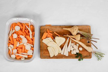 Parsnip and parsley root comparison, FRESH with leaves only from the garden, on a white background .