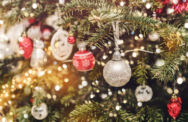 Christmas tree background and Christmas decorations with bokeh, blurred, sparking, glowing. Happy New Year and Xmas card, winter holiday, toning